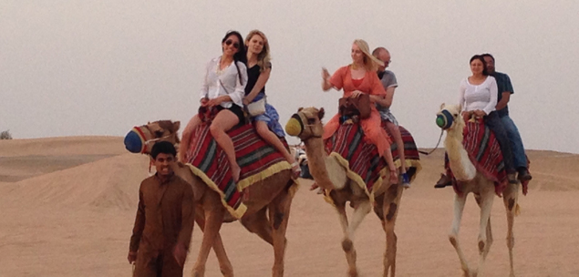 Students ride camels in Dubai as part of Real Estate Around the World