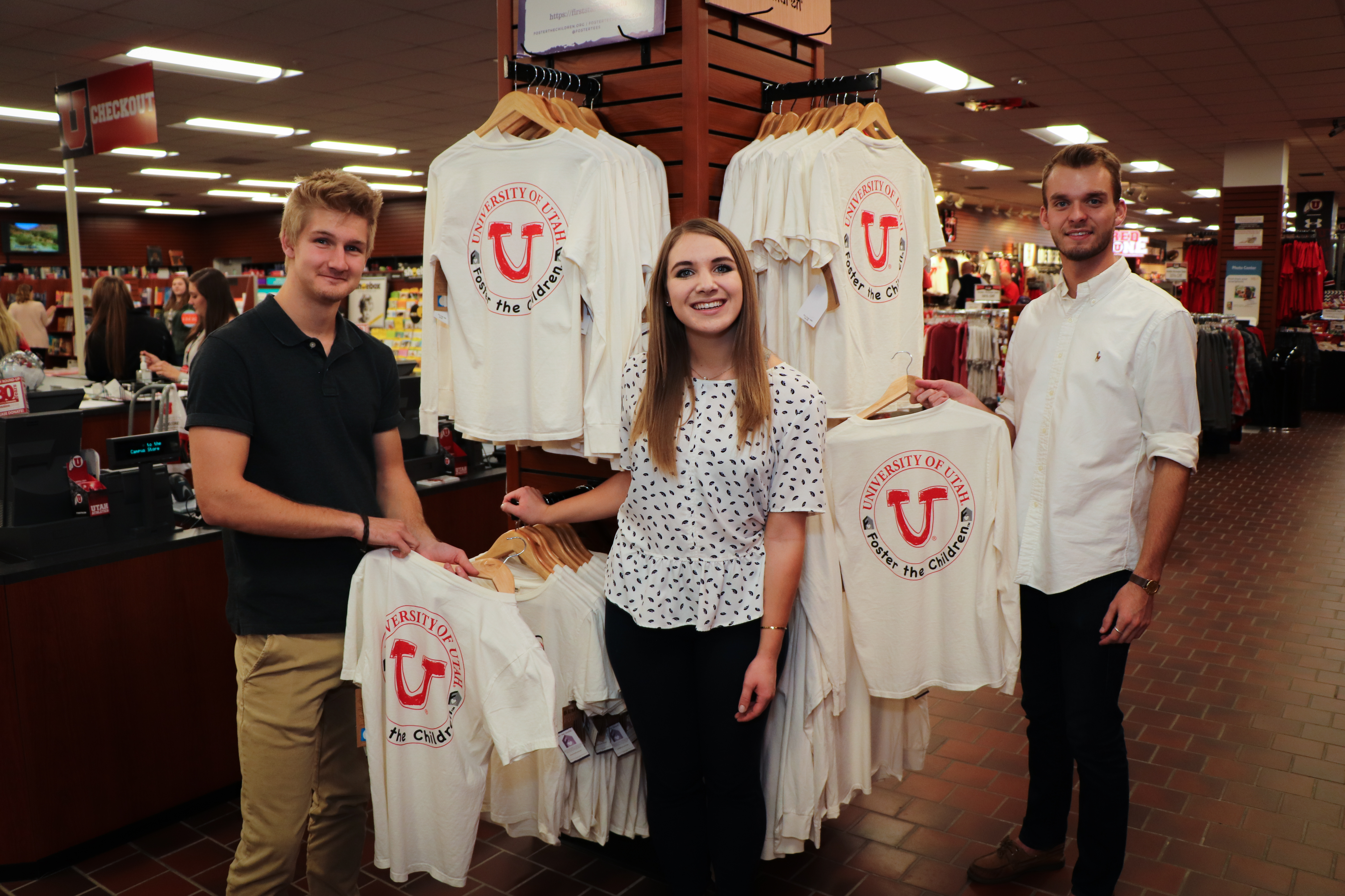 Megan Pollard poses with T-shirts from her company Foster the Children.