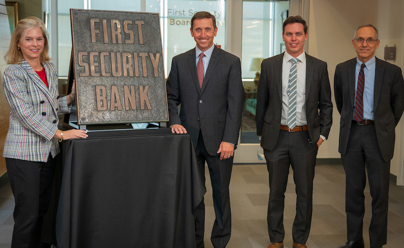 The Youngs and YESCO present Lisa Eccles with the First Security Bank sign